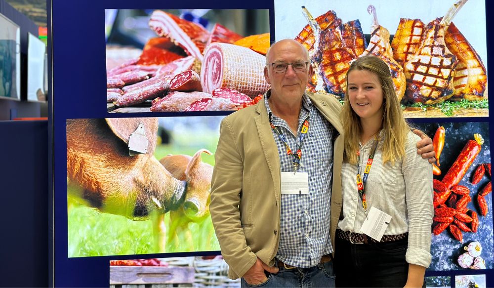 A man and young woman (father and daughter) stood in front of on-stand photography at Anuga 2023